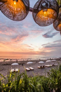 Bali beach sunset with luxury loungers and ocean views for romantic Bali tour packages by Roameaze