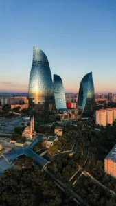 Flame Towers rising above Baku city at sunset in Azerbaijan