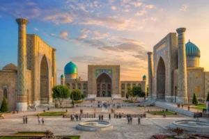Travellers exploring Registan Square on an Uzbekistan tour package from India with Roameaze